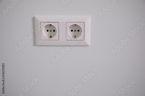 white electrical plugs in the home wall
