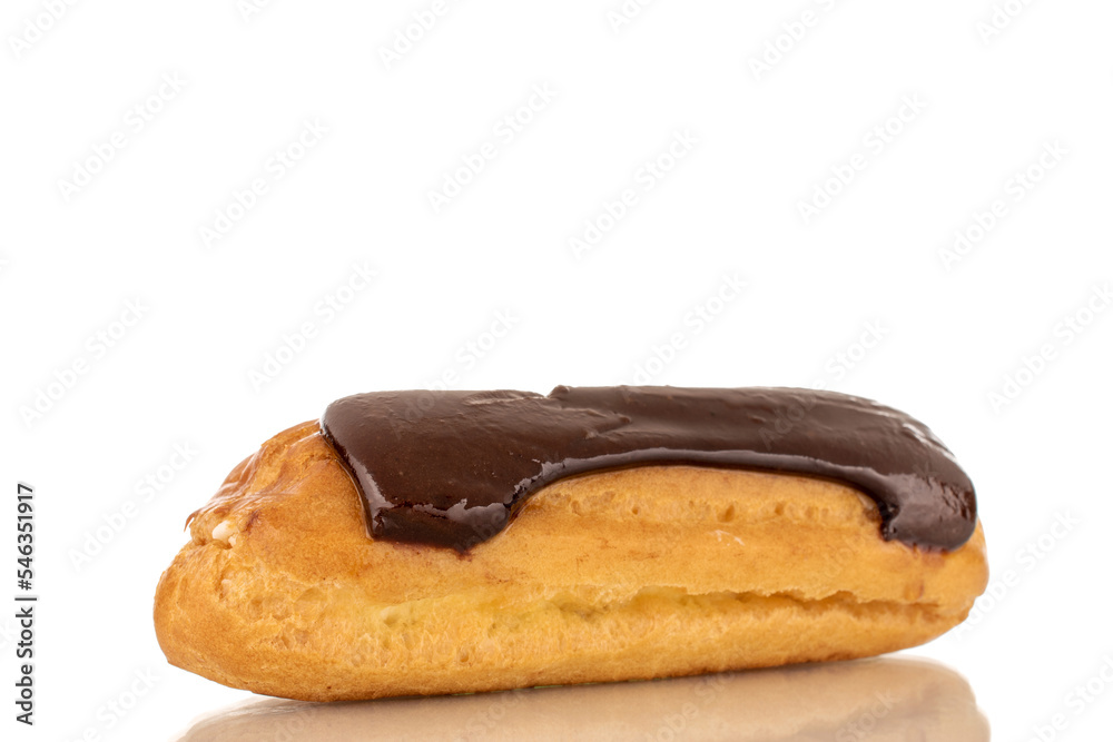 One sweet chocolate eclair on a white background, macro. One sweet chocolate eclair on a white background, macro.