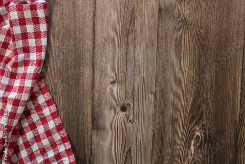 Wooden table with red and white checkered tablecloth