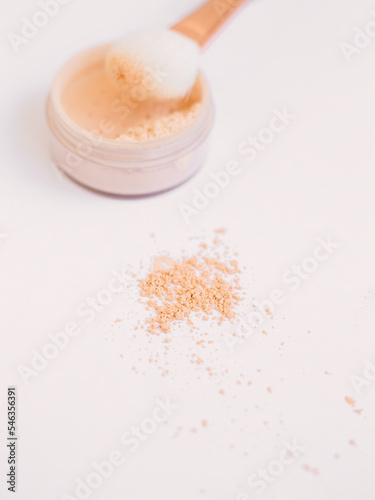 the powder is scattered on the table. Delicate photography in a beige hue. Facial