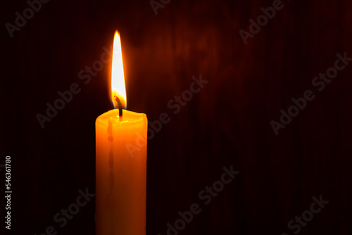 lighting a candle with a match in the dark. Copy space