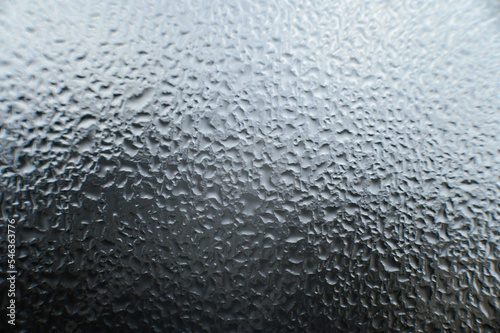 Texture on the window made of condensation and water drops.