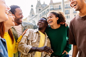 Young group of happy people having fun outdoors. Millennial diverse friends laughing enjoying travel vacation together in Barcelona