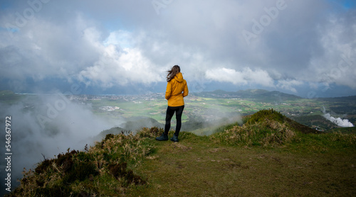 Female thinking. Retrospective. Thinking about adventure. Mysterious mountain with clouds and girl. New me resolution.
