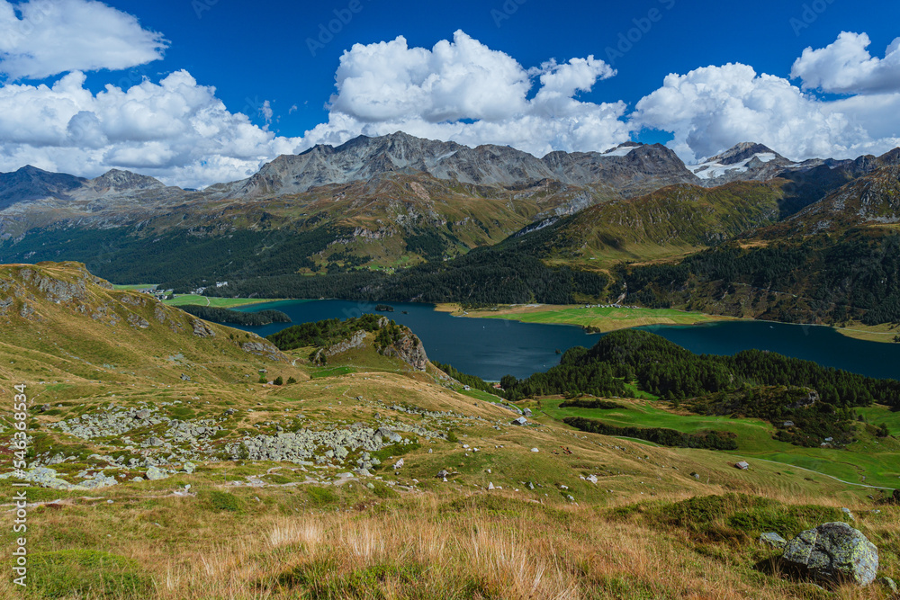 The landscape and the panorama of the European Alps seen from a summit of the Engadine, Piz Grevalsavas, near the village of Sankt Moritz, Switzerland - August 2022.