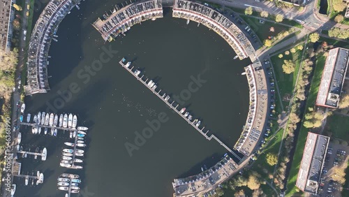 Harbour of Weesp, Aquamarin around the former industrial harbor. Suburban residential real estate housing in the shape of a circle. Small port recreactional living along the water. Aerial. photo