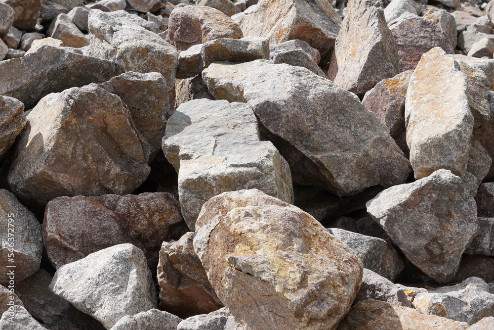 Close up view on light colored pile of Stones as building materials. Picture can by use as background and has a lot of copy space. 