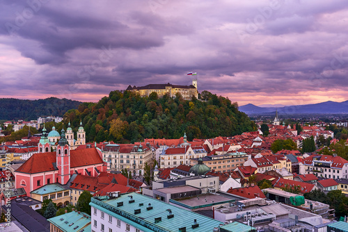 The Ljubljana castle during sunset under a cloudy sky photo