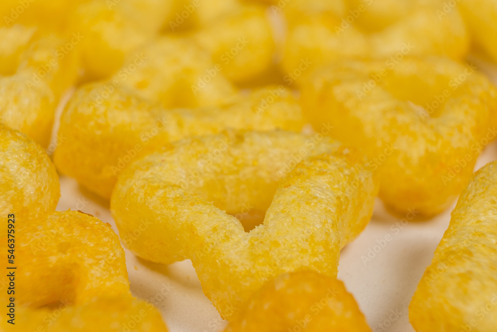 Delicious crispy corn chips triangular shape with spices, macro. Delicious crispy corn chips triangular shape with spices, macro.