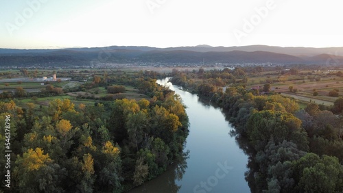 Aerial view of a deep river surrounded with dense forests photo