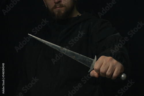 hand holding medieval antique dagger knife