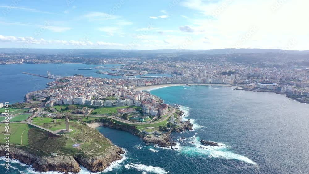 A Coruna, Galicia, SPAIN. View of Tower of Hercules and Aquarium. In background is the city of A Coruna and his famous beach Orzán. Drone backward ascending. Travel destination in northwest of Spain A Coruna, Galicia, SPAIN. View of Tower of Hercules and Aquarium. In background is the city of A Coruna and his famous beach Orzán. Drone backward ascending. Travel destination in northwest of Spain