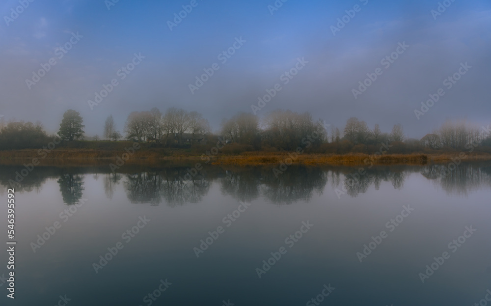 Landscape view on the river and coast. Symmetrical Alignment Water Reflections.