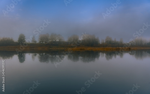 Landscape view on the river and coast. Symmetrical Alignment Water Reflections.