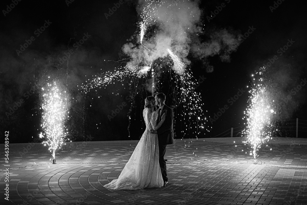 the wedding couple stands looking at the fireworks the wedding couple stands looking at the fireworks