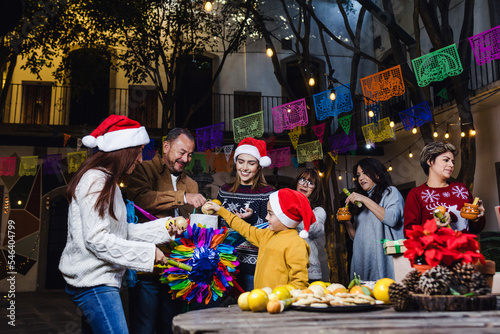 Posada  Mexican family Singing carols in Christmas party in Mexico Latin people