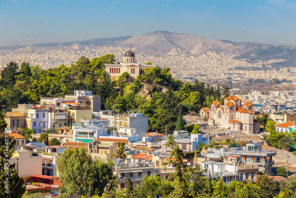 Fototapeta premium Residential Homes in a Historic City with Cityscape and Mountains in Background. Areopagus Hill, Athens, Greece.