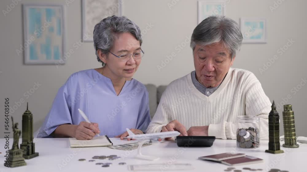 Happy Asian senior couple plans to save money for a trip around the world. Travel budget concept Happy Asian senior couple plans to save money for a trip around the world. Travel budget concept