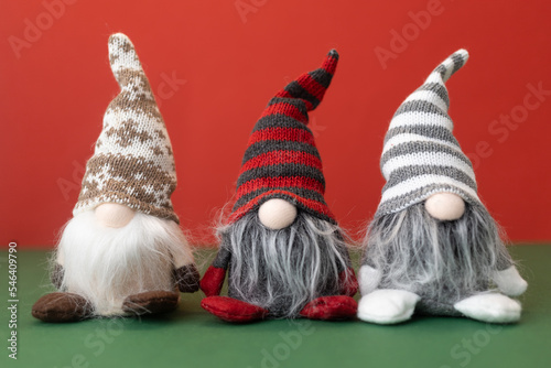three little christmas gnomes gonks on red background