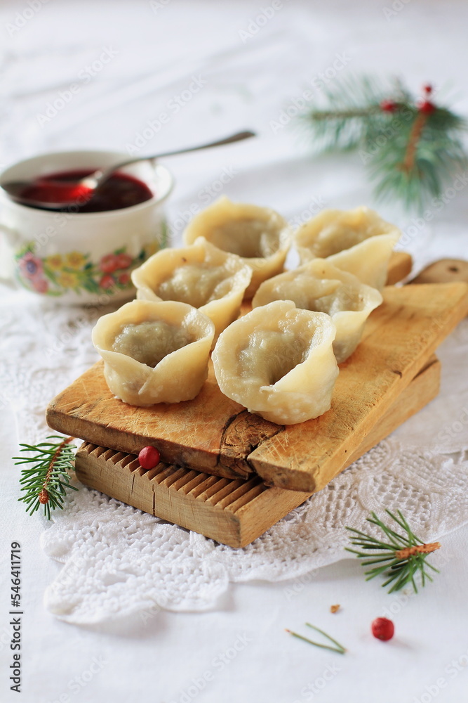 Homemade Christmas dumplings on a festive table, traditional Polish dumplings with cabbage and mushrooms, Christmas mood, culinary magazine.