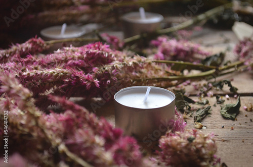 Dead Celosia Flowers with Candles on a Rustic Wood Background | Romantic Dead Flowers | Candles with Flowers photo