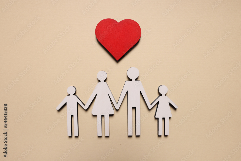 Figures of family and heart on beige background, top view. Insurance concept Figures of family and heart on beige background, top view. Insurance concept
