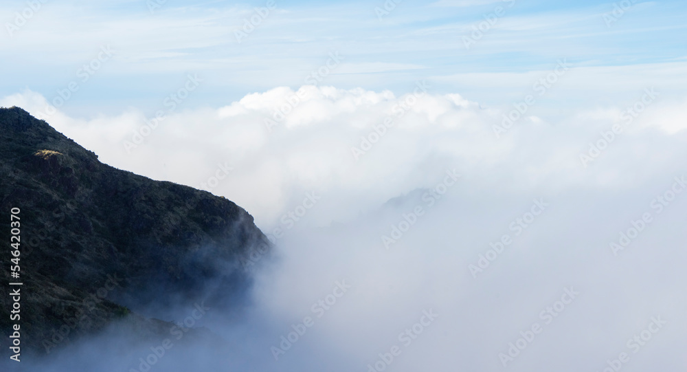 Side of a mountain with fog and clouds. Cloud banner copy space. 