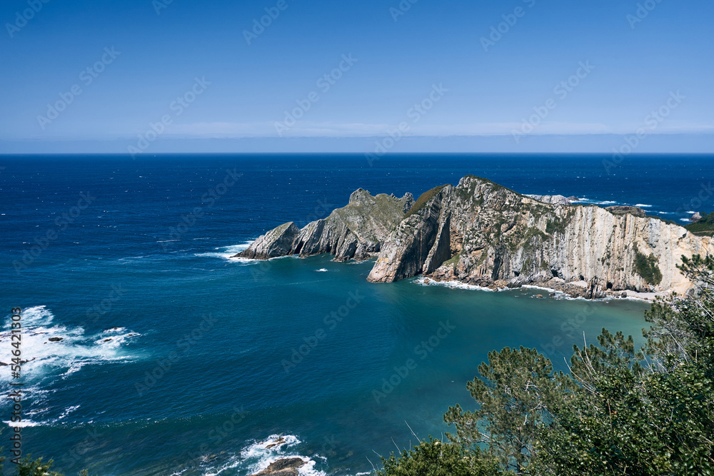 nice landscape of the cantabrian sea with different shades of blue and green near the big cliffs and the violent waves, asturias, spain