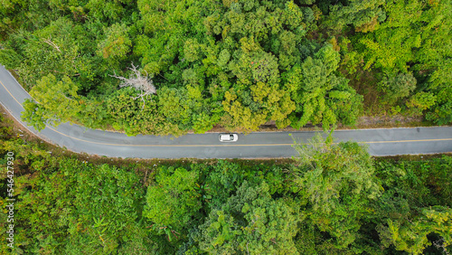 Aerial view asphalt road through green tropical rainforest nature landscape.