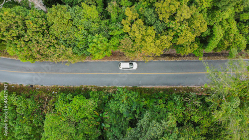 Aerial view asphalt road through green tropical rainforest nature landscape.