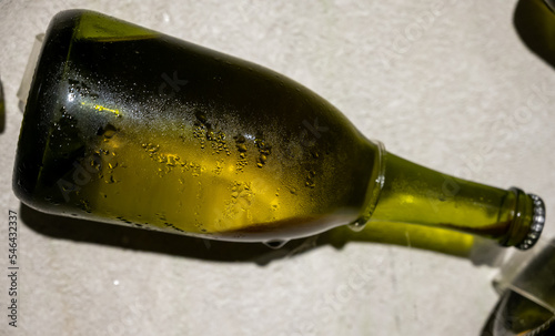 Champagne bottle during second fermentation with lees or dead yeast cells, making champagne sparkling wine from chardonnay and pinor noir grapes in Epernay, Champagne, France photo