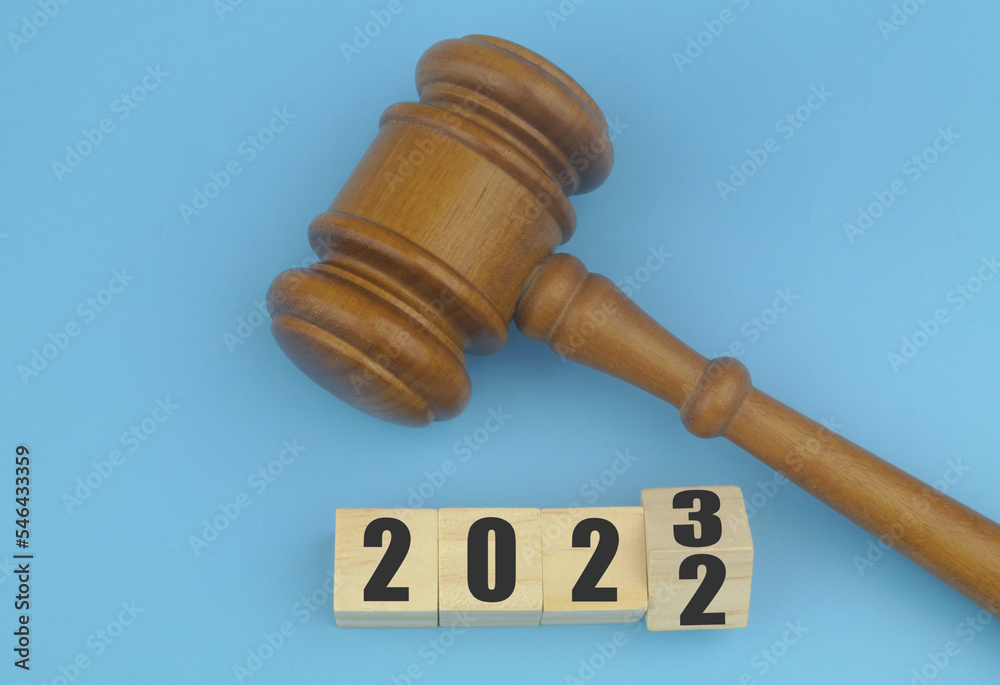Judge gavel and flipping numbers 2022 with 2023 on wooden cubes. Concept of changes in laws in year 2023. Judge gavel and flipping numbers 2022 with 2023 on wooden cubes. Concept of changes in laws in year 2023.