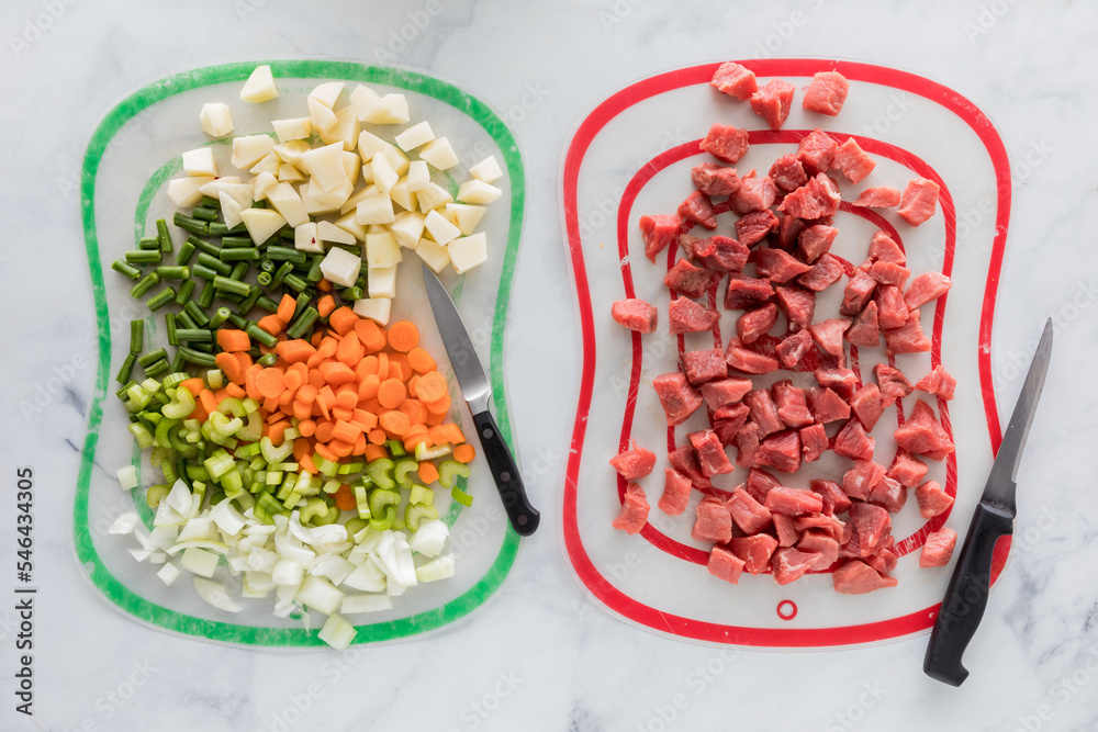 Chopped beef stew ingredients on different mats to prevent cross