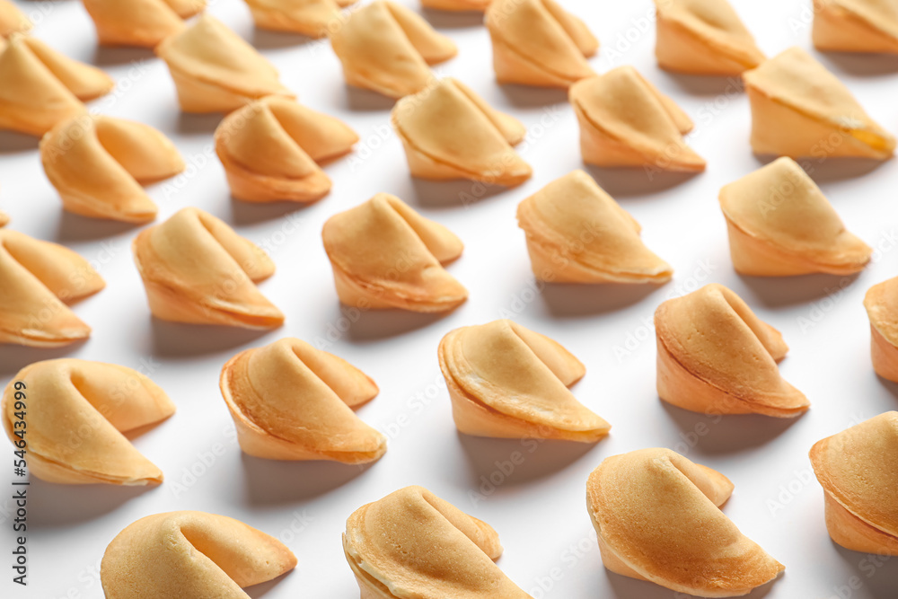 Many tasty fortune cookies with predictions on white background Many tasty fortune cookies with predictions on white background