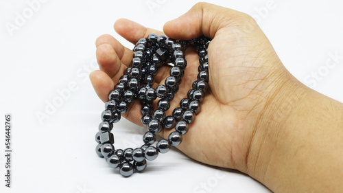 tasbih from silver berries as a counting tool in Muslim worship after praying isolated white