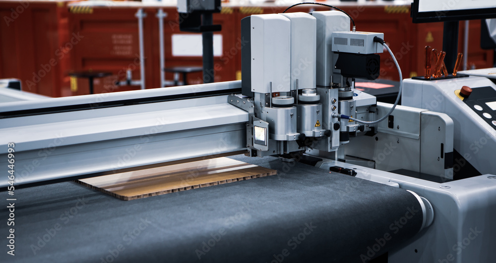 Digital laser die cut machine cutting corrugated cardboard. Industrial manufacture. Digital laser die cut machine cutting corrugated cardboard. Industrial manufacture.