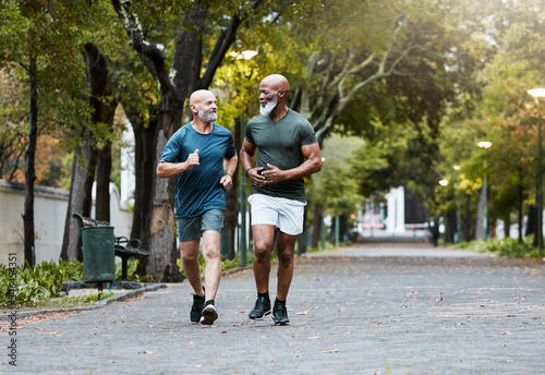 Mature, men and fitness with friends running in park for exercise, workout and wellness. Exercising, working out and diverse male athletic friend in cardio training for body health and stamina photo