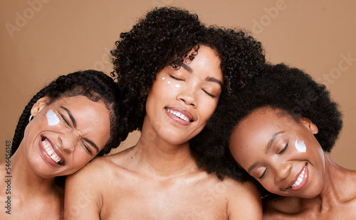 Skincare, cream and woman group in studio for beauty, facial product and cosmetics on face with self love, self care and support. Happy diversity girl model or friends with sunscreen for dermatology