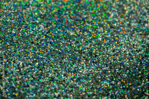 Macro image of a sparkling green and blue color glitter texture background