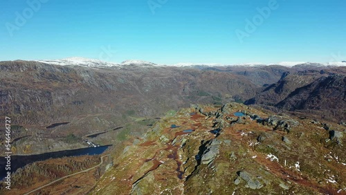 Revealing Nesheim and Bergo in Eksingedalen valley Norway from nearby mountain top - Sunny autumn day forward moving aerial looking down at Bergo freshwater lake photo