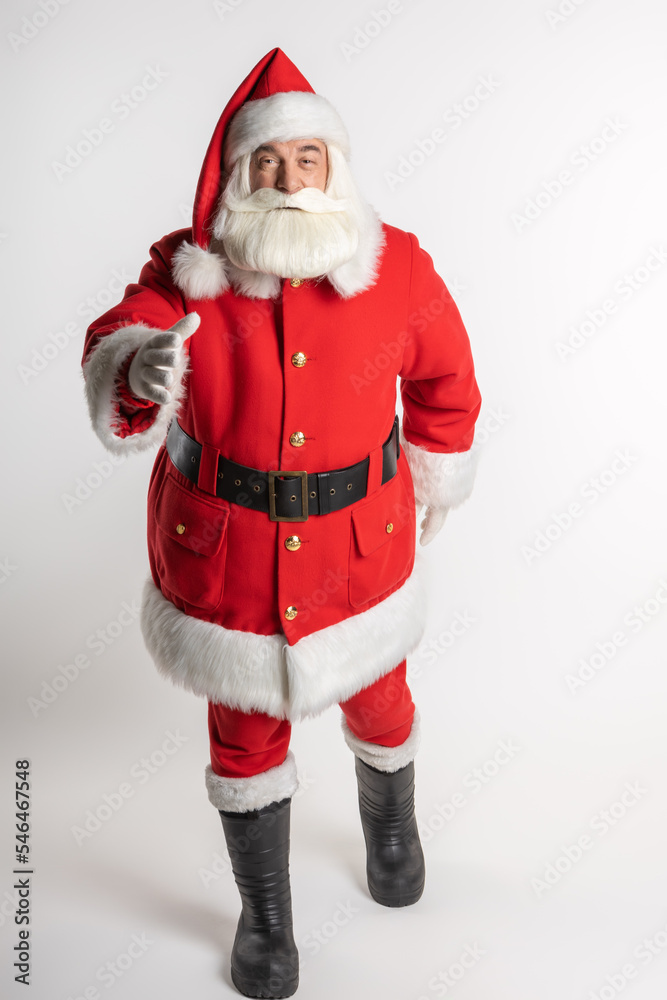 Bearded Santa Claus walking straight towards the camera in a red suit, in front of a white background. Bearded Santa Claus walking straight towards the camera in a red suit, in front of a white background.