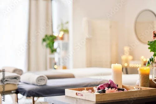 Fototapeta na wymiar Candle, spa and relax with aromatherapy treatment in a tray in a room for luxury or wellness. Background, health and massage with still life in an empty resort for peace, skincare or relaxation