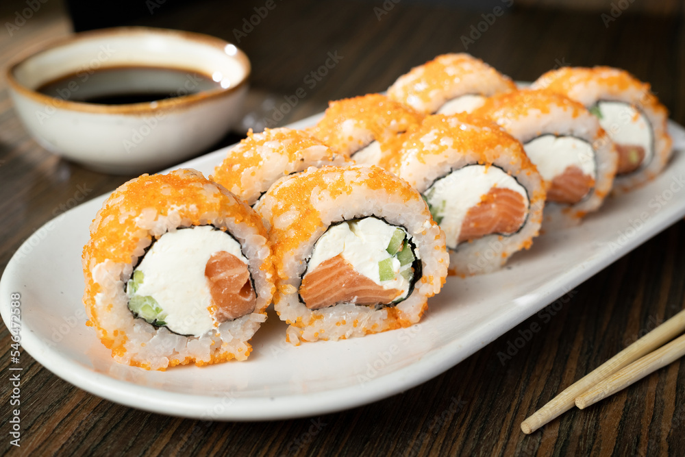 closeup of sushi rolls with chopsticks and soy sauce closeup of sushi rolls with chopsticks and soy sauce