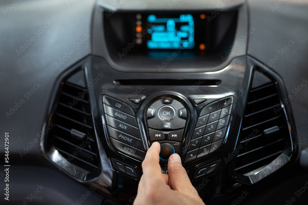 Driver's hand controls car stereo with automatic climate and temperature control system