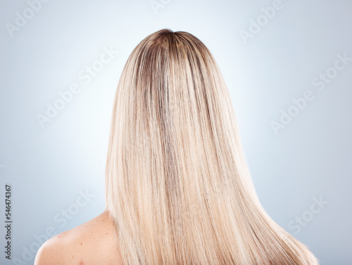 Hair, beauty and keratin with a model woman in studio on a gray background to promote a haircare product. Salon, shampoo and treatment with long, strong or healthy hair at the back of a female head