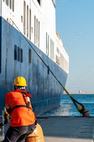 Dock worker pulling ship rope