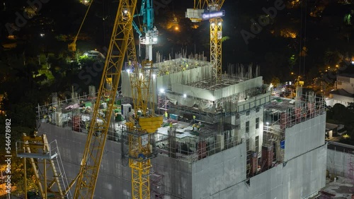 Time lapse aerial view of construction site with tower crane urban construction Rush hour of concrete pouring