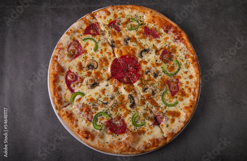 Tasty peroni pizza on rustic background. Top view of hot pepperoni pizza.
