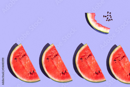 pattern from watermelon on a purple background. fruits on a purple table. juicy ripe watermelon on the dining table. fruit pattern