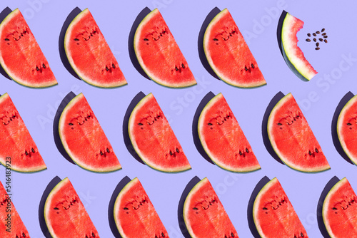 pattern from watermelon on a purple background. fruits on a purple table. juicy ripe watermelon on the dining table. fruit pattern